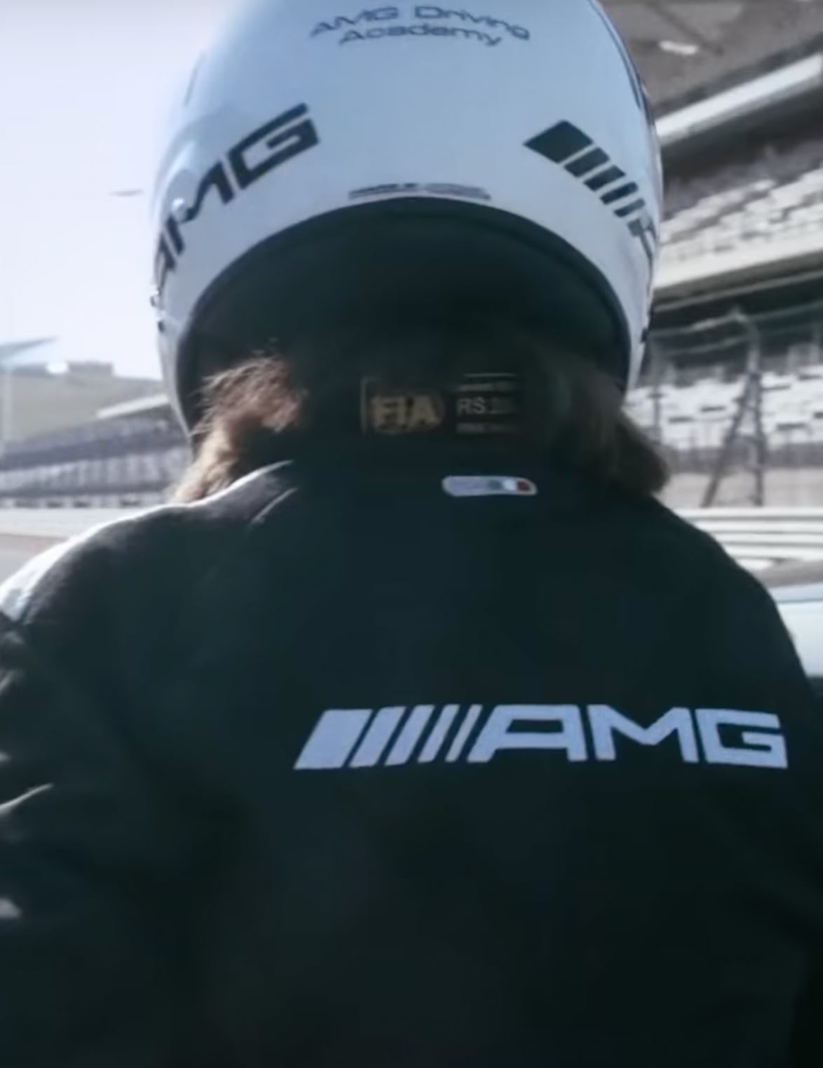 A photo of Debra Bennet, race driver, standing on the race track for Mercedes-AMG.
