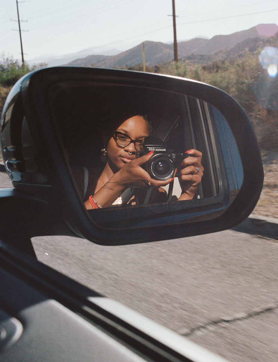 Picture of Alicia Keys photographing herself in a Mercedes-Benz.
